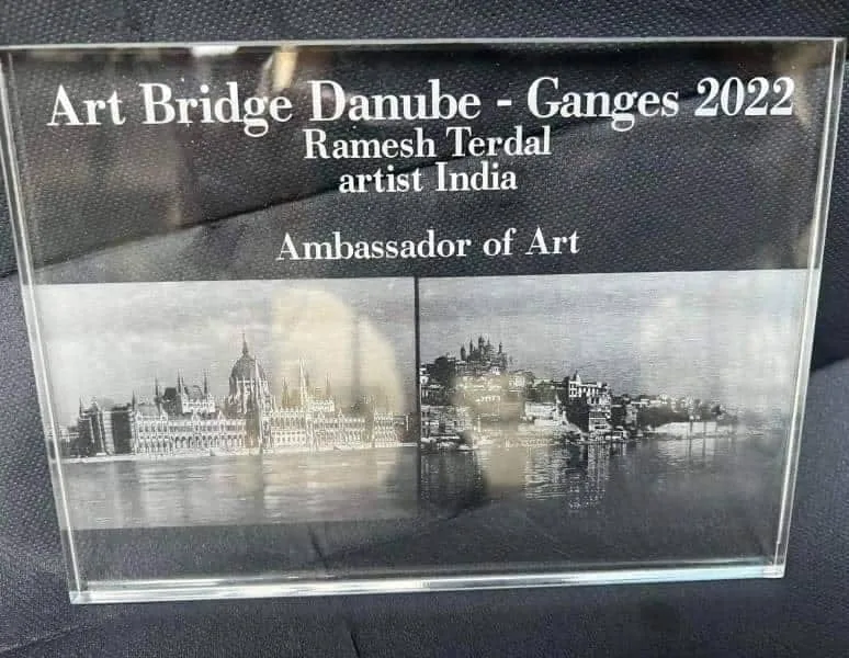 Glass plaque reading Art Bridge Danube - Ganges 2022, Ramesh Terdal, artist India, Ambassador of Art