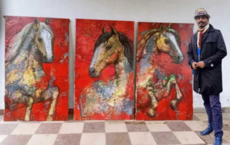 Three red horse paintings displayed side by side with the artist